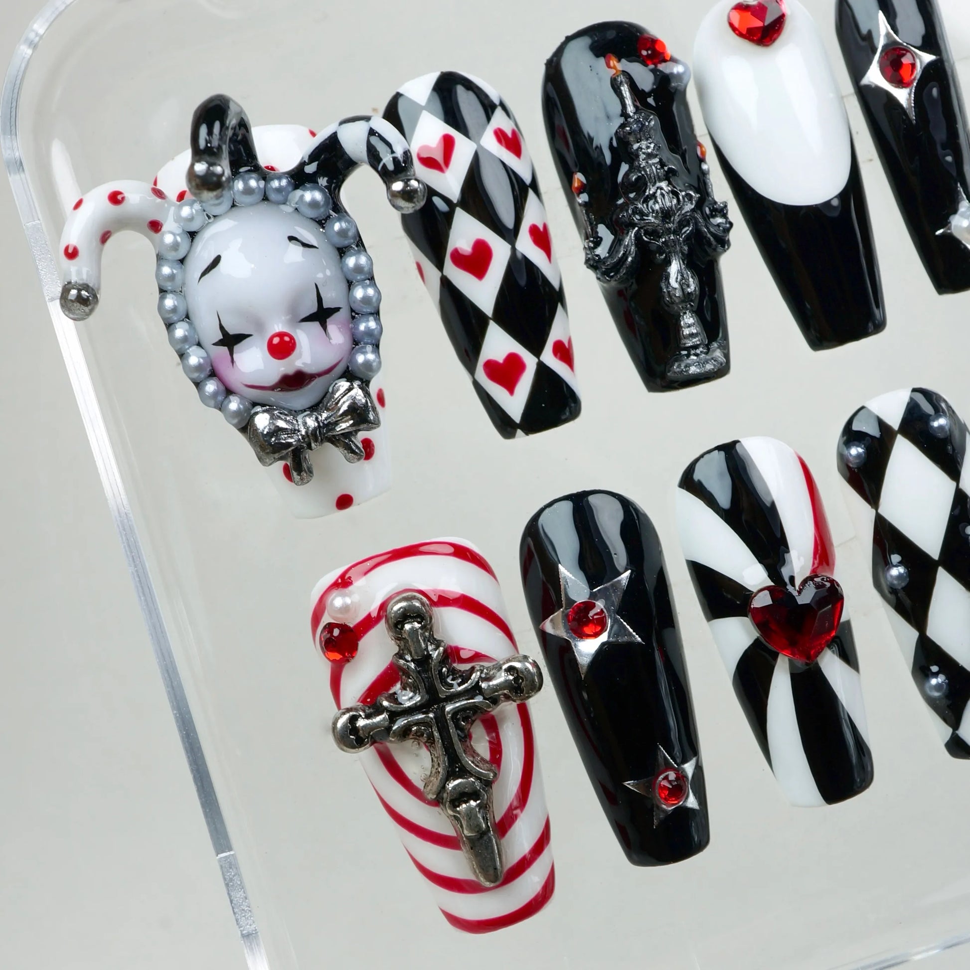 Donailsart press-on nails with circus gothic flair – featuring diamonds, hearts, and a statement clown piece.