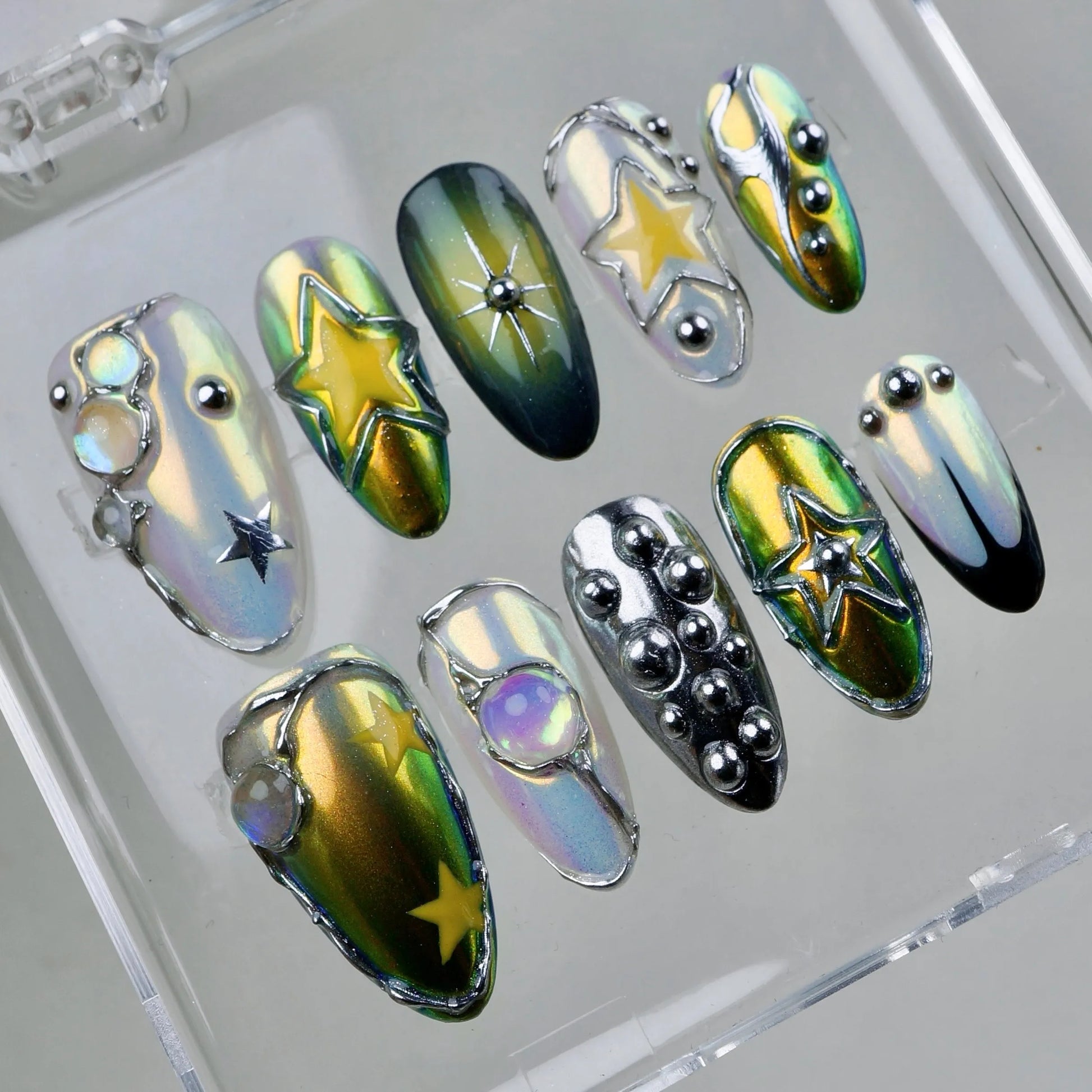 Celestial glam meets futuristic edge—these cosmic nails twinkle with stars, chrome shine, and galactic gemstones.