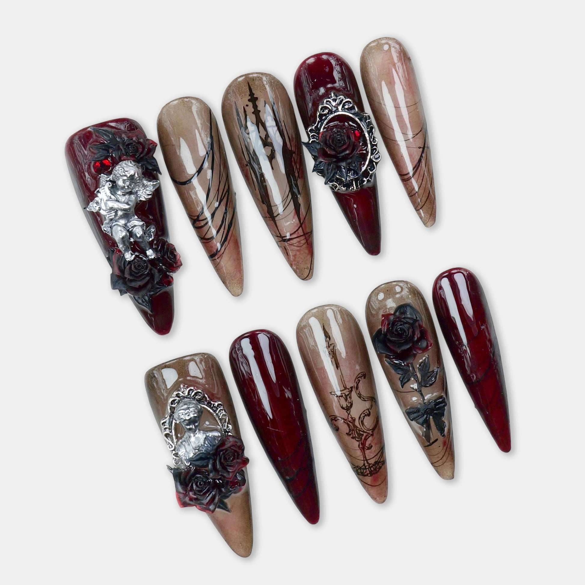 Gothic nails in deep wine and smoky nude tones with black rose art, metallic angels, and candle motifs – by Donailsart.