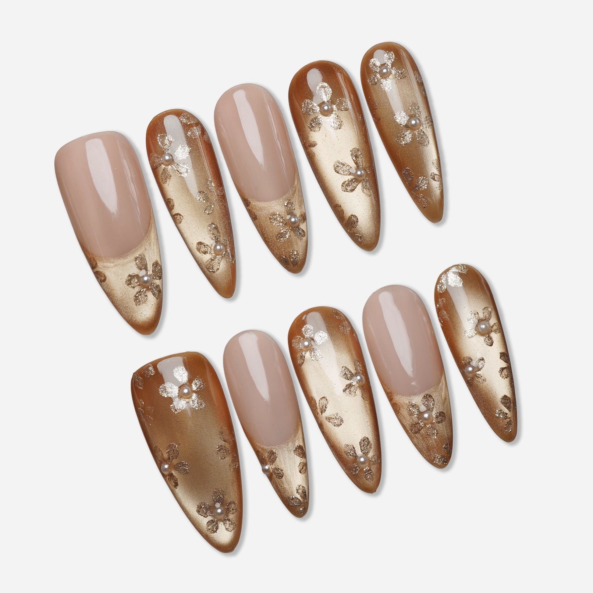 Gilded Whisper press-on nail set by Donailsart – champagne gold gradient nails with a sheer nude base, delicate floral detailing, and tiny pearl accents