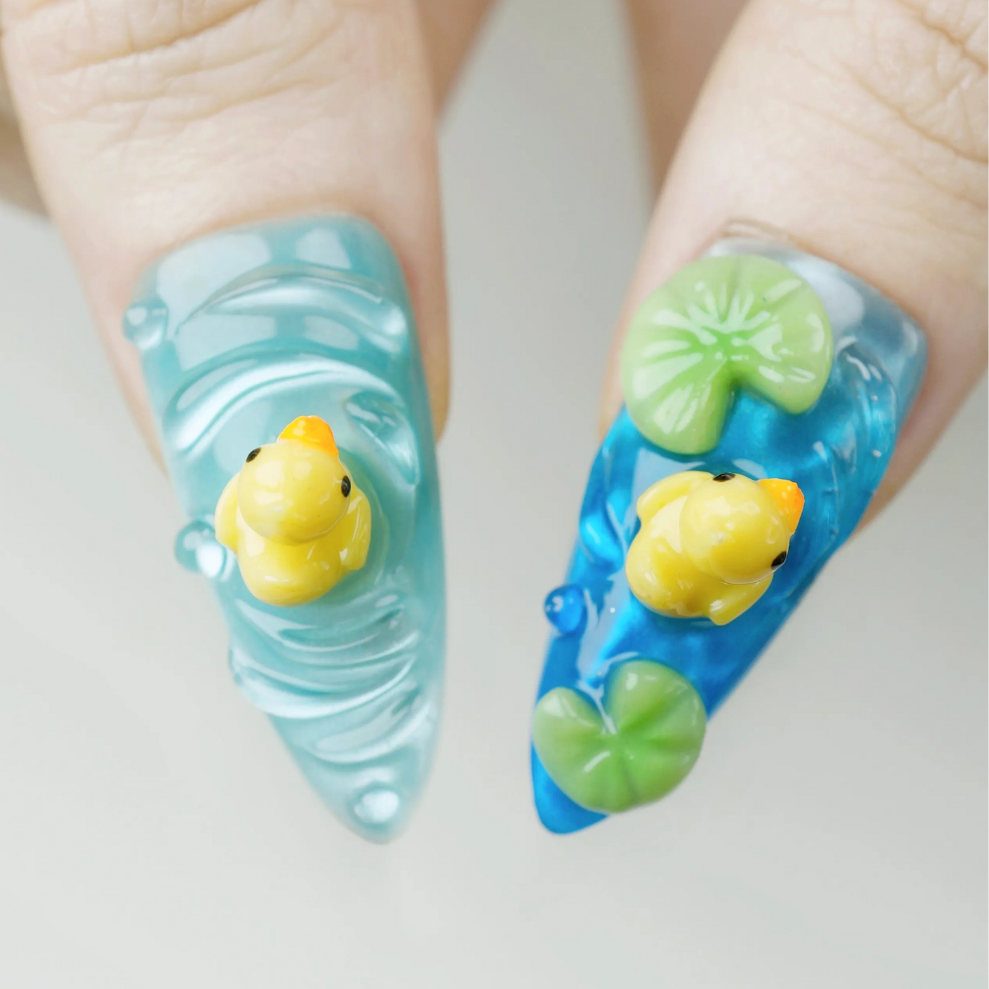 Nails with rubber duck and wave design on a light background