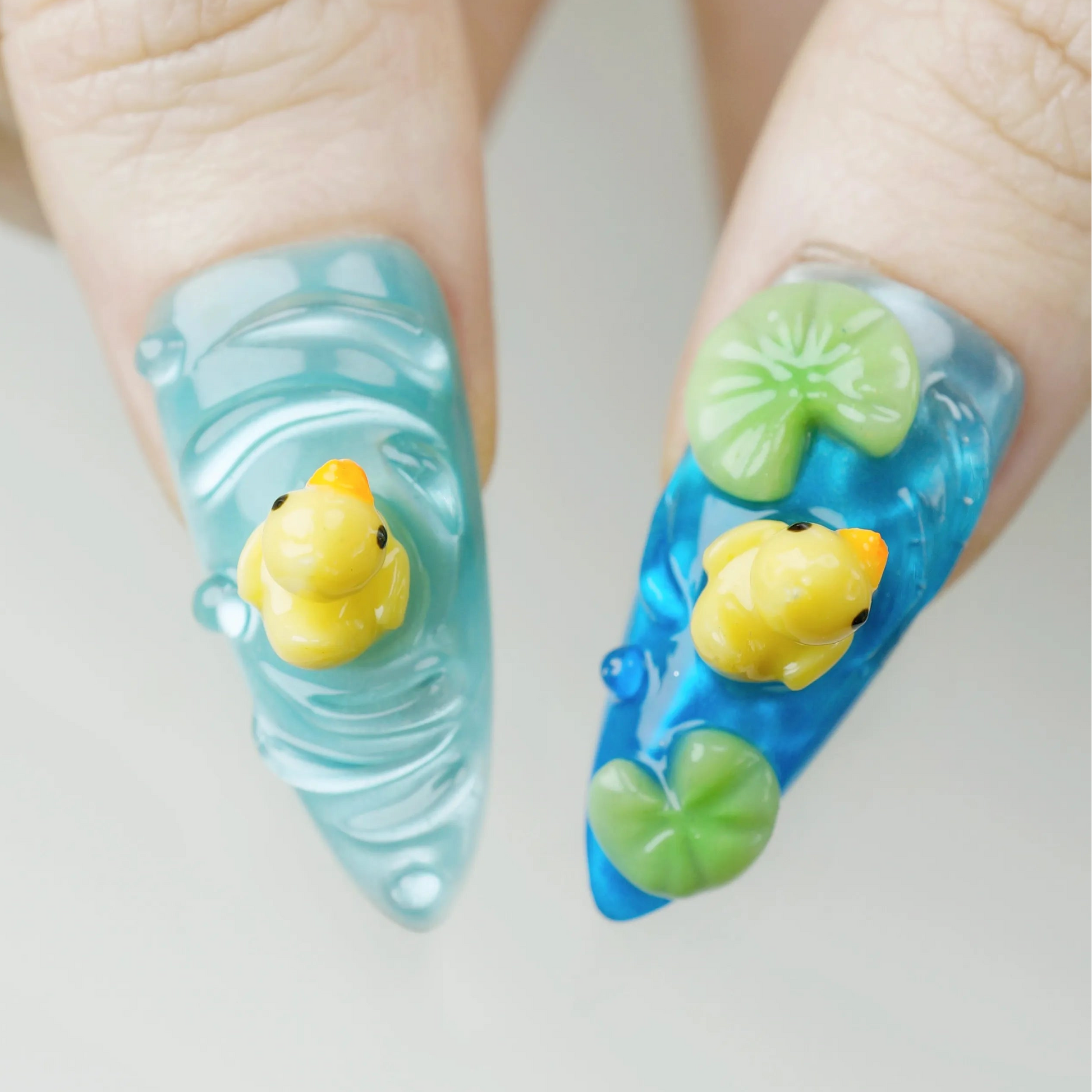 Nails with rubber duck and wave design on a light background
