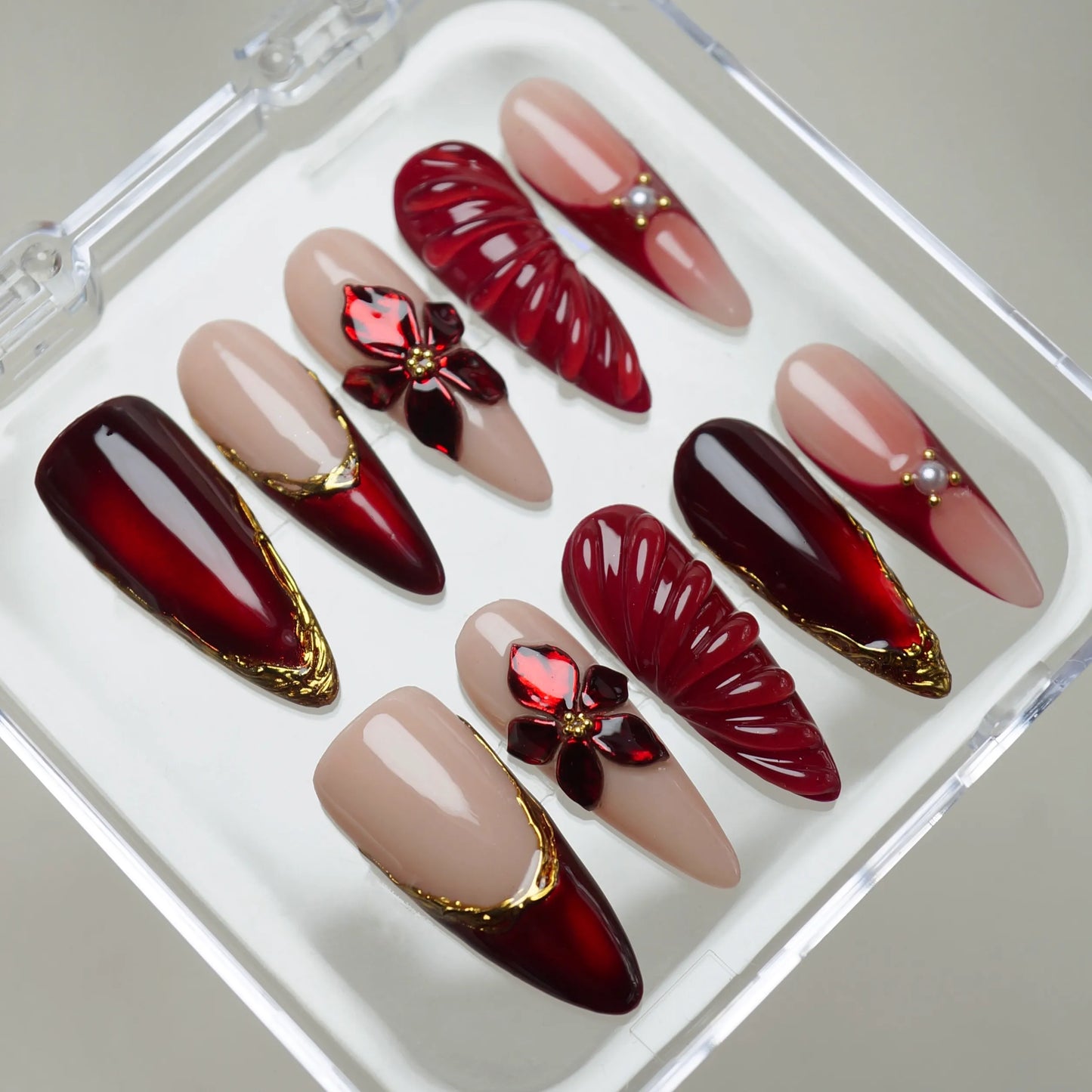 Ruby Poinsettia press-on nails on hand – Donailsart