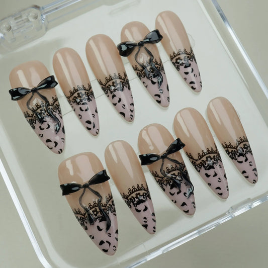 Noir Étreinte press-on nails on display showing the full nude and black lace bow nail art collection – Donailsart