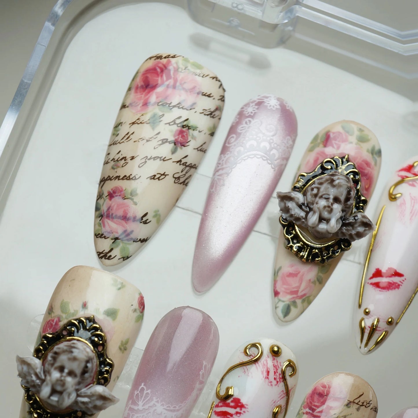 Cherub Relique press-on nails side angle showing romantic lace texture and gold cherub nail art – Donailsart