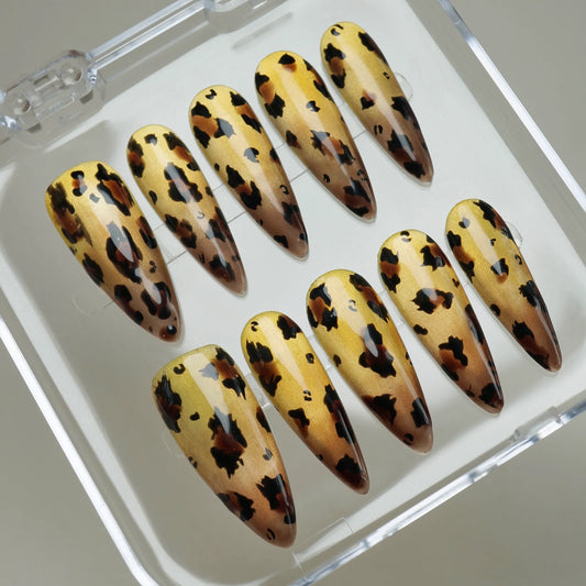 Gilded Wild press-on nails on display showing the full metallic gold and tortoiseshell leopard nail art collection – Donailsart