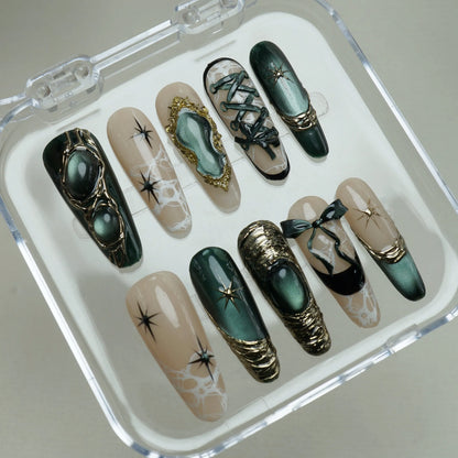 Velour Noire press-on nails on display showing the full emerald cat-eye and gold lace nail art collection – Donailsart