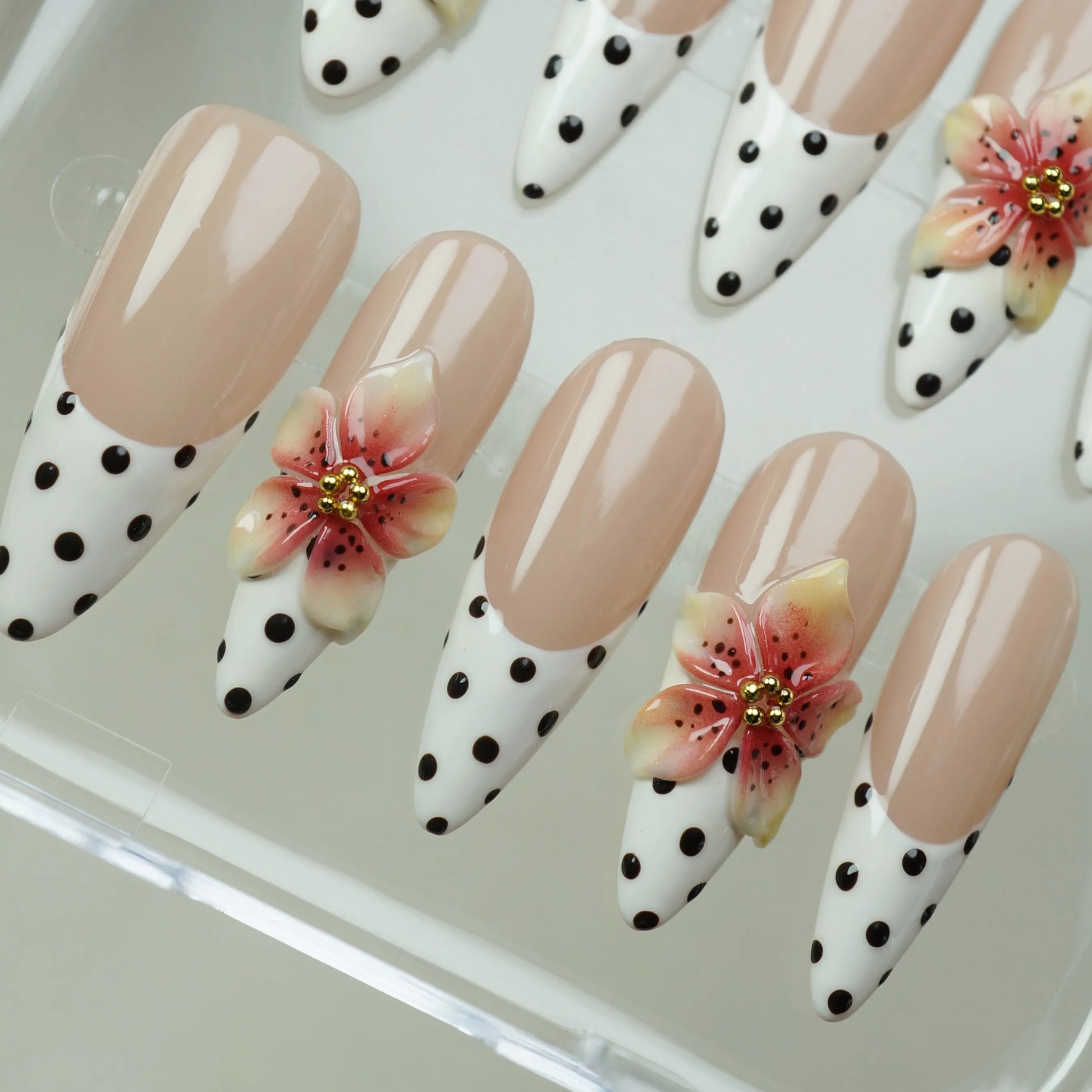 Petal Poise close-up detail showing graphic polka-dot French tip and sculpted 3D floral accent on a nude nail – Donailsart