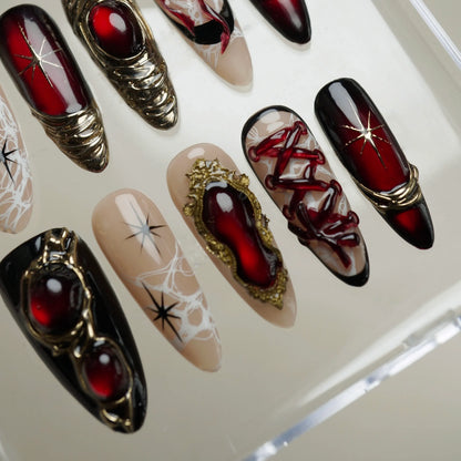 Royal Ruin press-on nail set product view with powerful deep crimson chrome, gold, and corset-inspired nail art by Donailsart
