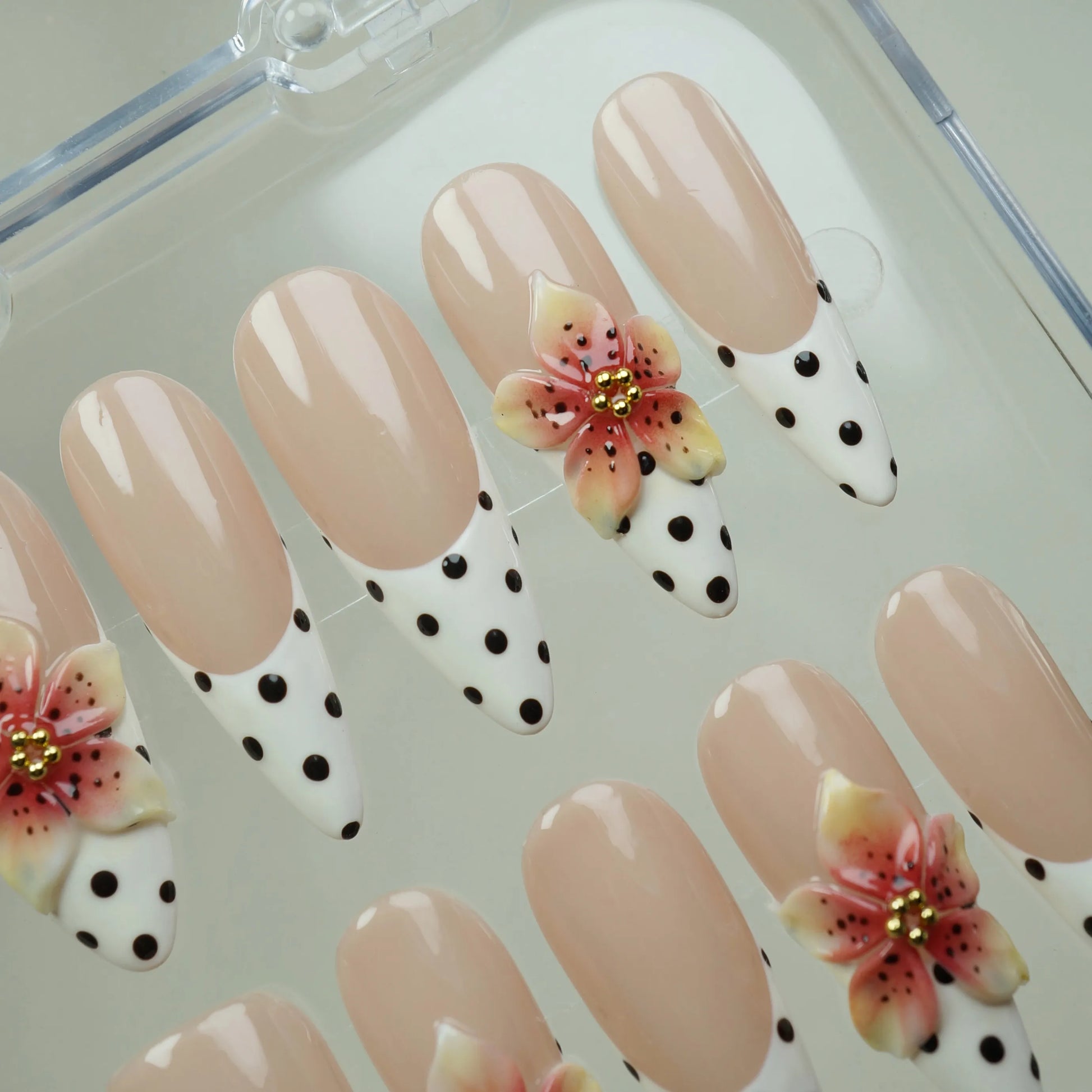 Petal Poise press-on nail set product view with charming nude, polka-dot French tip, and sculpted floral nail art by Donailsart