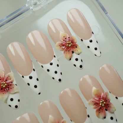Petal Poise press-on nail set product view with charming nude, polka-dot French tip, and sculpted floral nail art by Donailsart