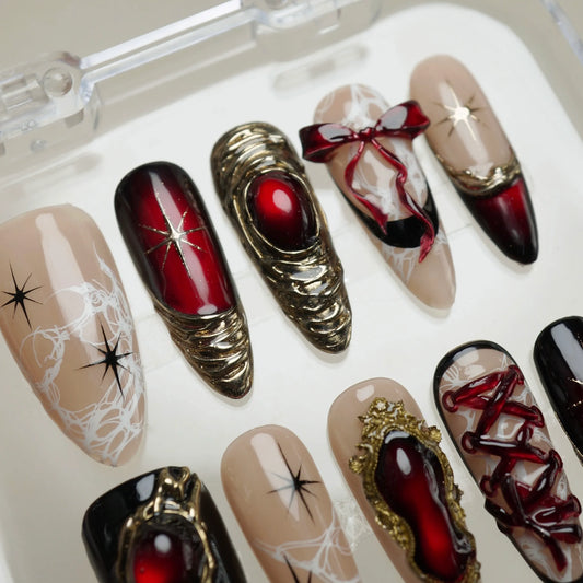 Royal Ruin press-on nails on display showing the full dark crimson chrome and gold corset nail art collection – Donailsart
