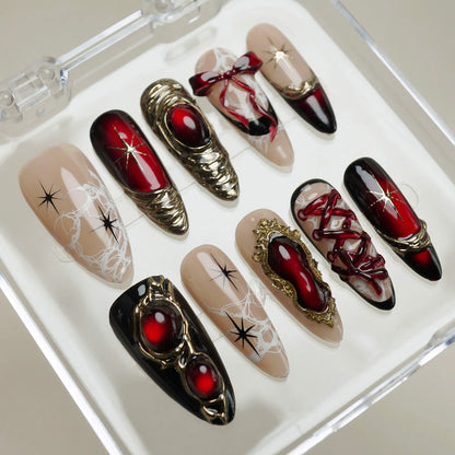 Royal Ruin close-up detail showing sculpted gold corset lacing and ribbon accents on deep crimson chrome nails – Donailsart