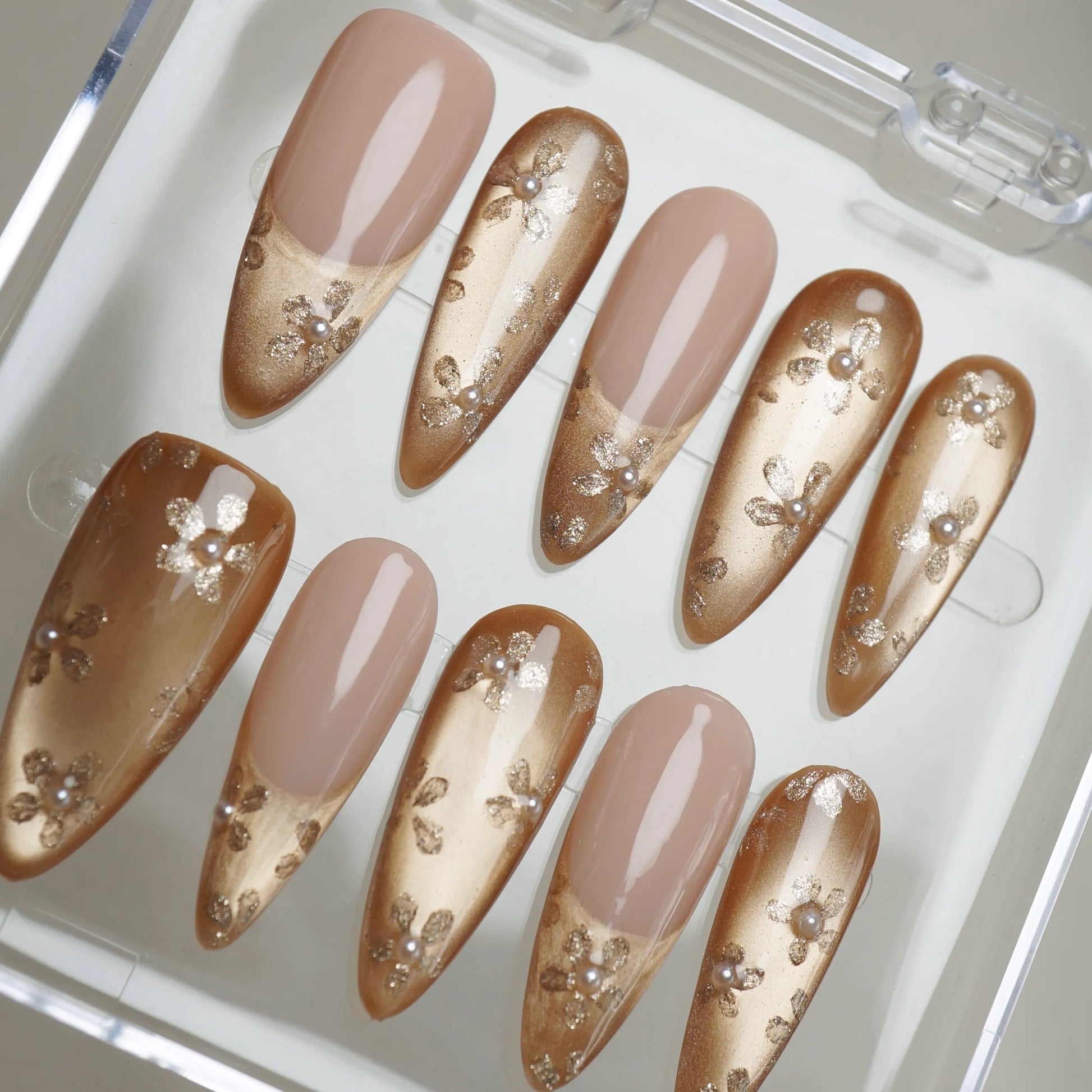 Gilded Whisper close-up detail showing soft gold gradient and delicate floral with pearl accents on a sheer nude nail – Donailsart