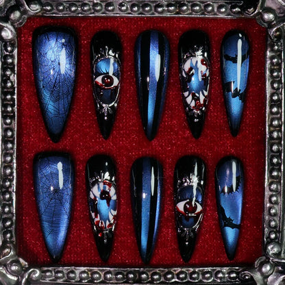 Azure Nightmare press-on nails: deep blue shimmer nails with framed eyeball cameos, spider webs and bats