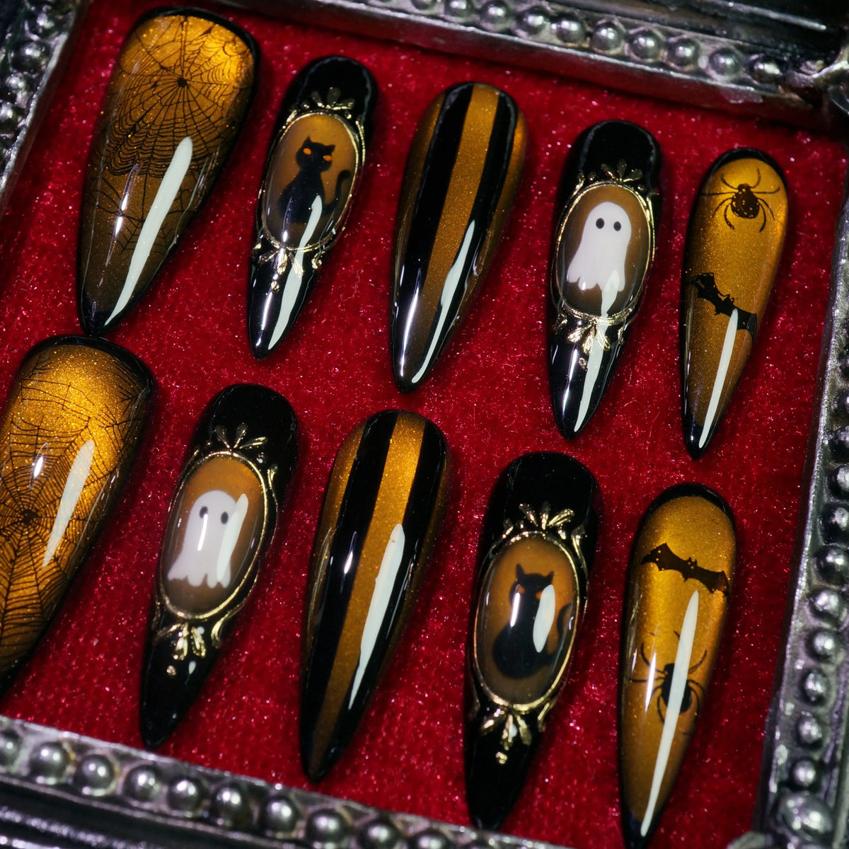 Amber Haunt press-on nails, detail shot of gold cameo Halloween frames