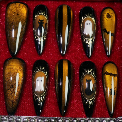 Amber Haunt press-on nails, side view of gold cameo Halloween frames