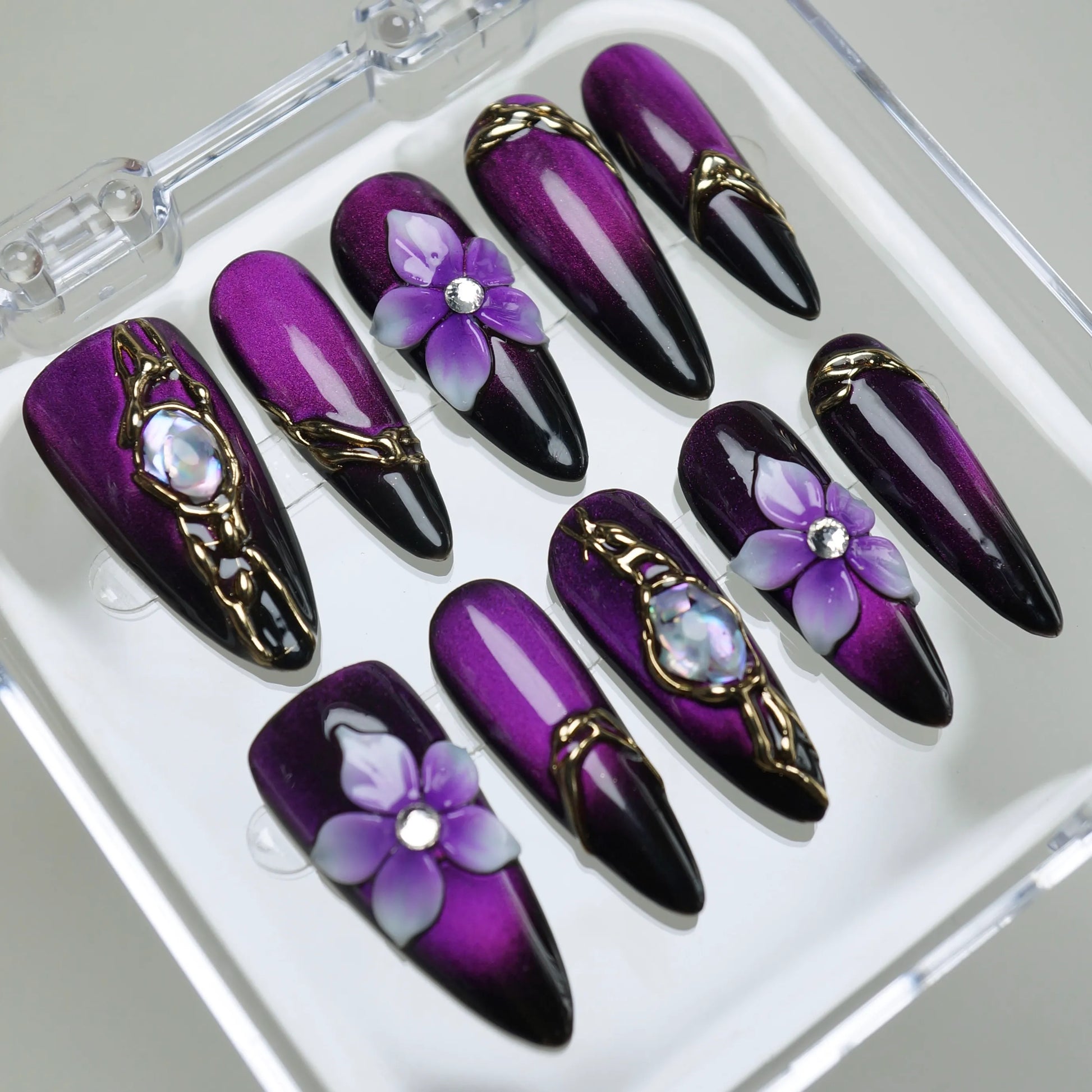 Veloria nail art detail view featuring gold frame and iridescent gemstone details on a dramatic purple gradient nail – Donailsart