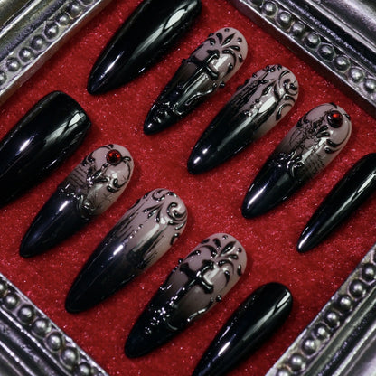 Manor of Shadows press-on nails, angled close-up of haunted-mansion art and filigree