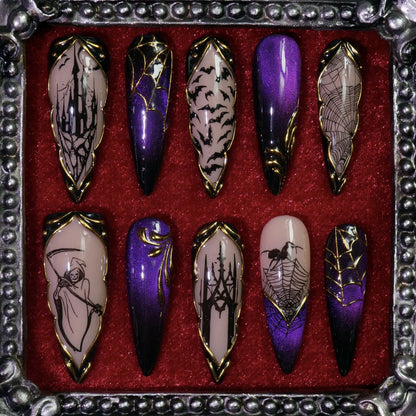 Haunted Hollow press-on nails: purple cat-eye and nude nails with a haunted house, bats, webs and a reaper in gold frames