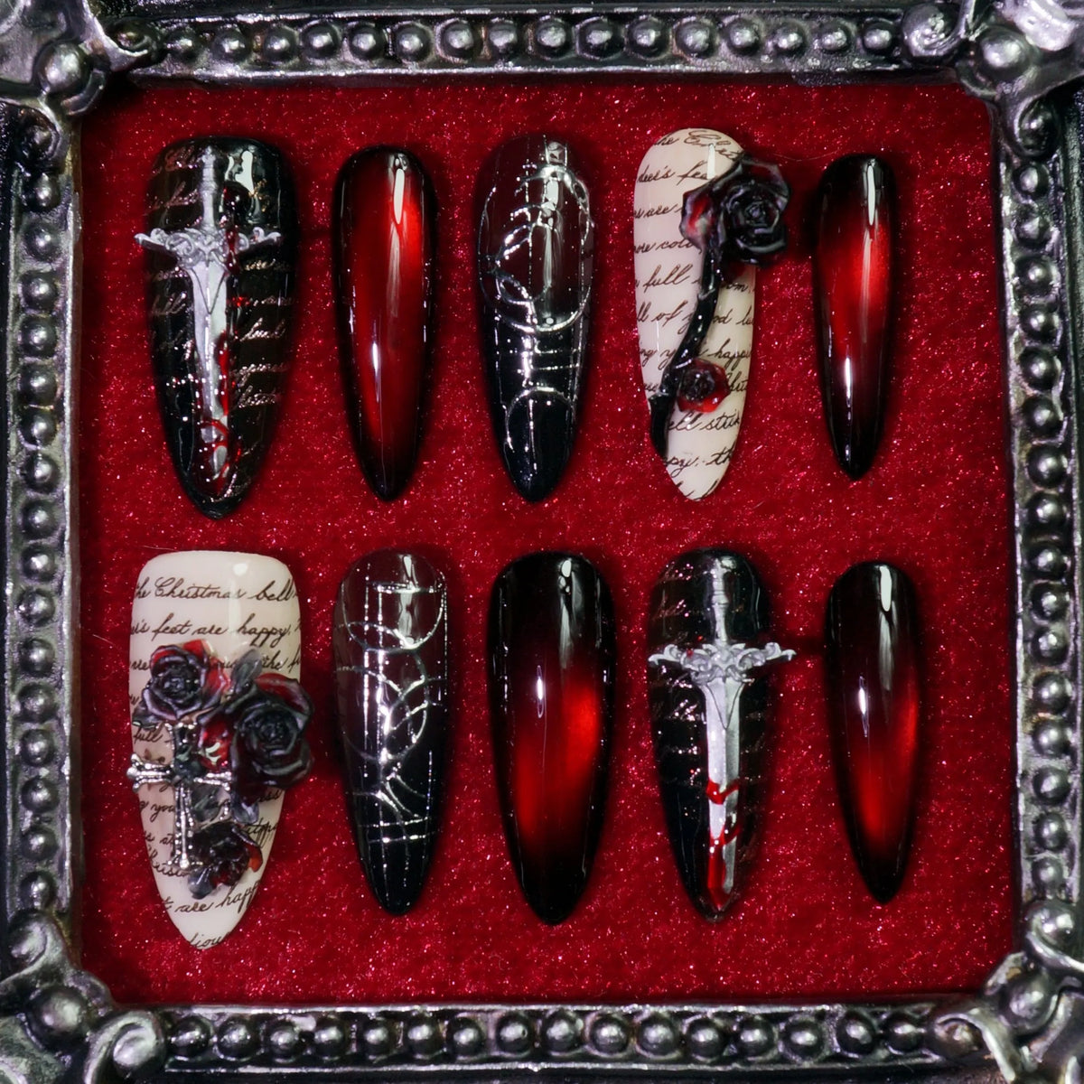 Gothic Requiem press-on nails: oxblood and black nails with silver daggers, black roses and antique script