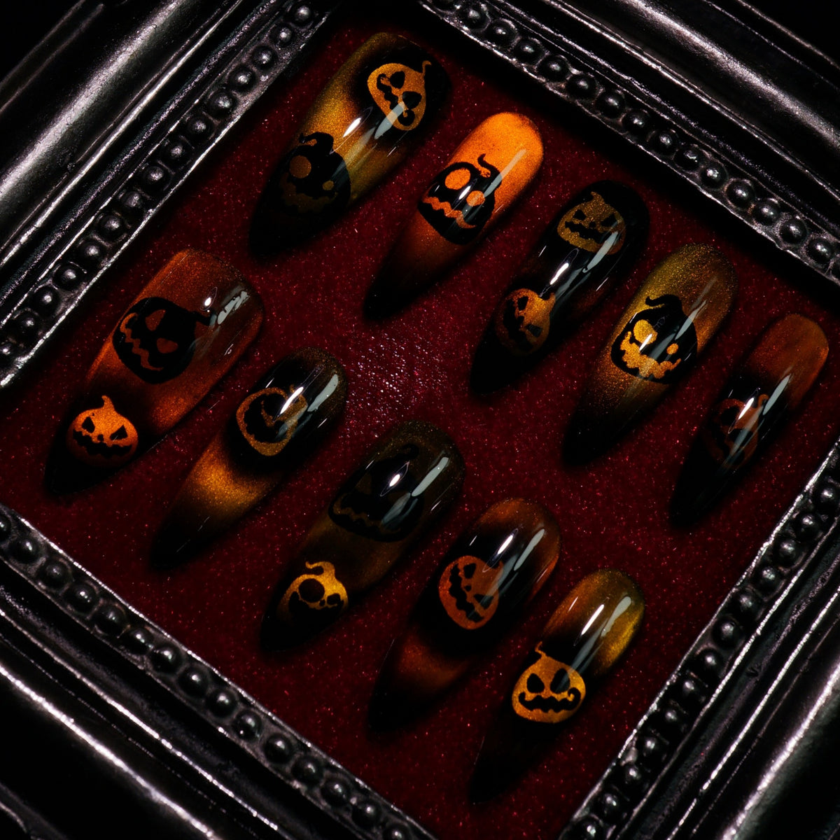 Pumpkin Curse press-on nails, close-up of jack-o'-lantern faces