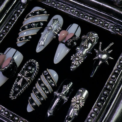Metallic Crush press-on nails, close-up of silver chains, studs and bows
