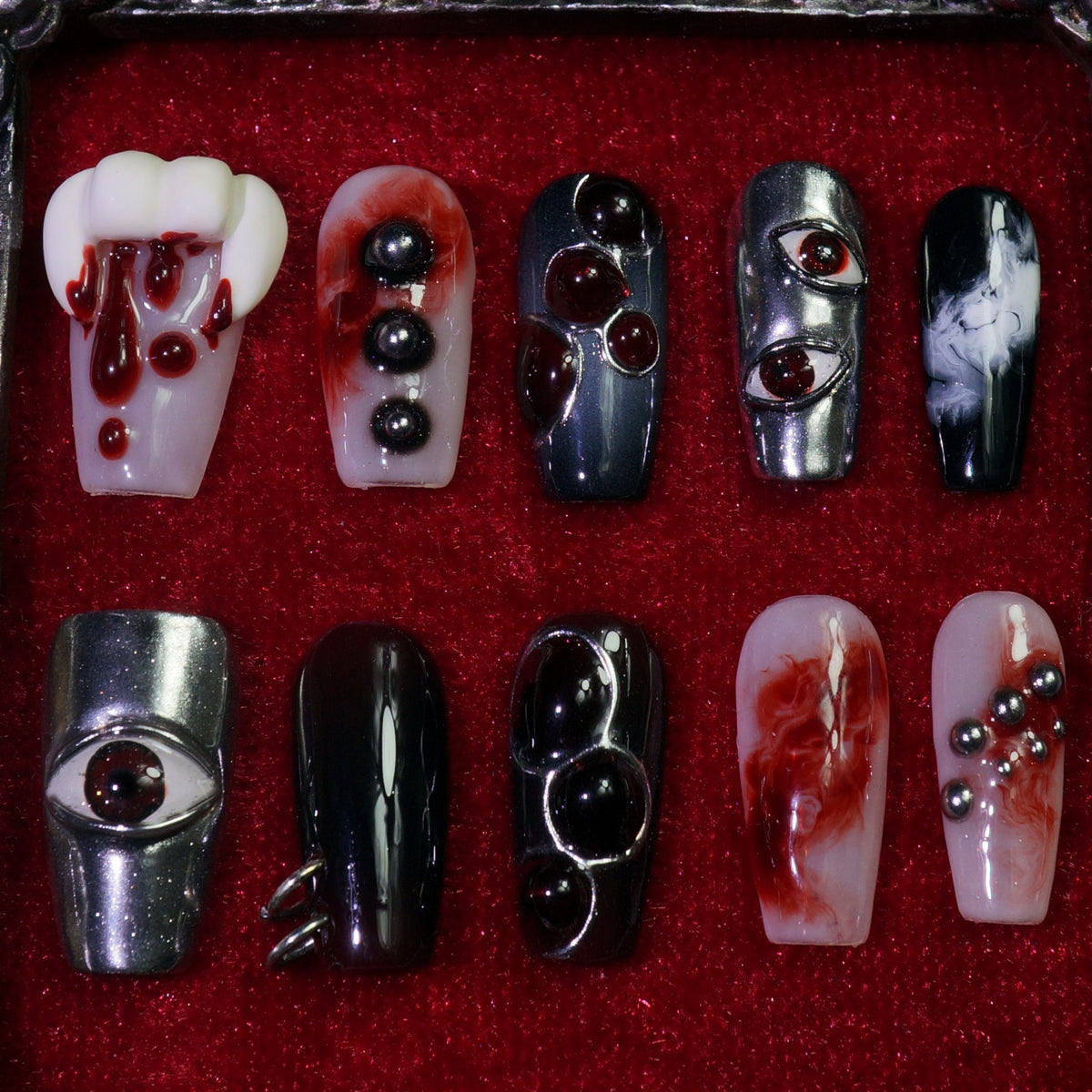 Vampire press-on nails, detail shot of vampire fangs and blood drips