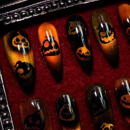 Pumpkin Curse press-on nails, detail shot of jack-o'-lantern faces
