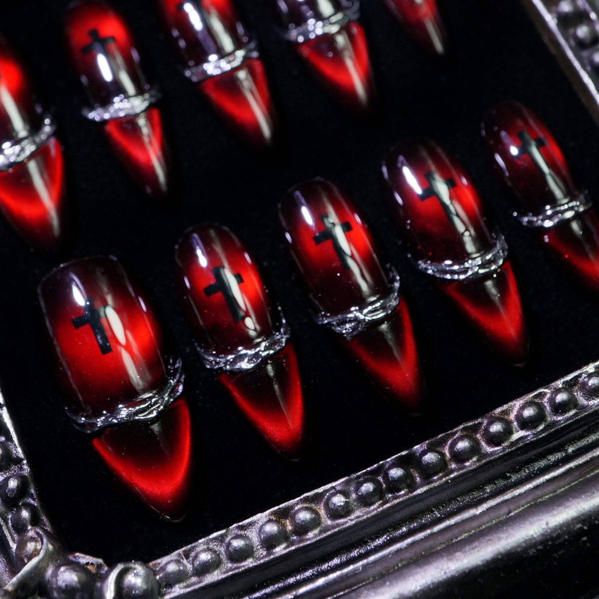 Sinner's Vow press-on nails, close-up of black cross and chrome band