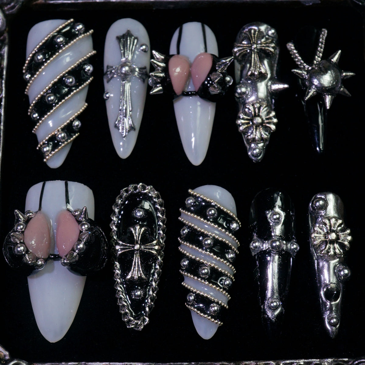 Metallic Crush press-on nails, detail shot of silver chains, studs and bows