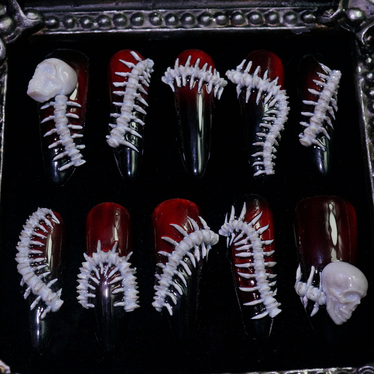Human Centipede press-on nails, detail shot of 3D bone spines and skulls