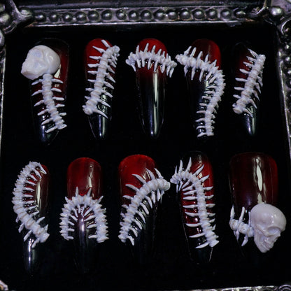 Human Centipede press-on nails, detail shot of 3D bone spines and skulls