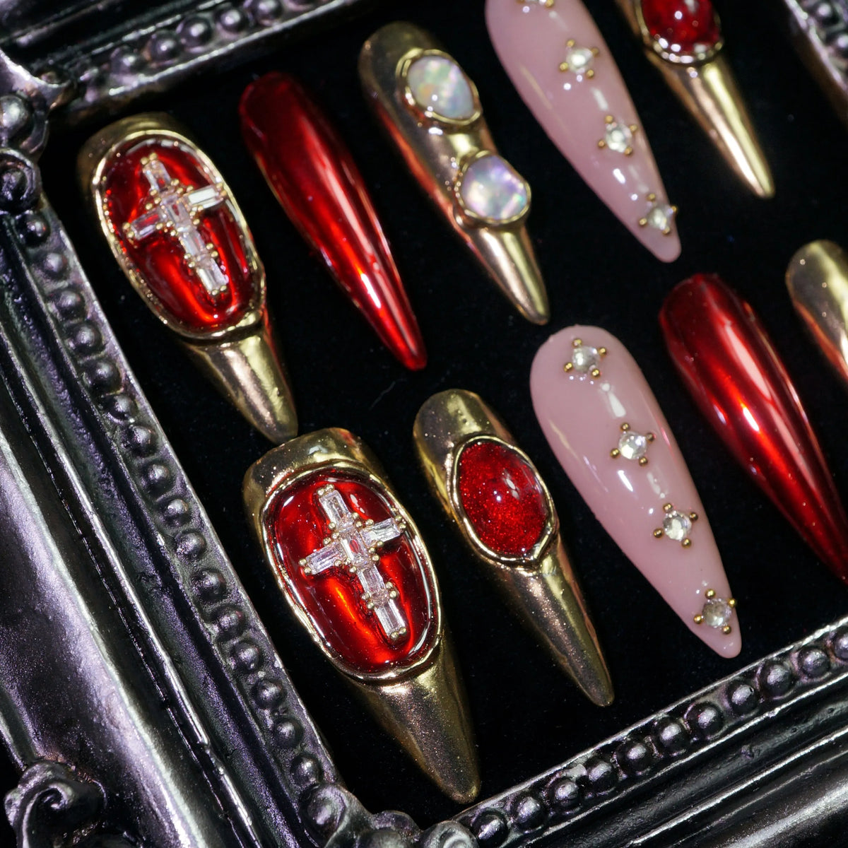 Crimson Regalia press-on nails, close-up of crosses, pearls and red gems