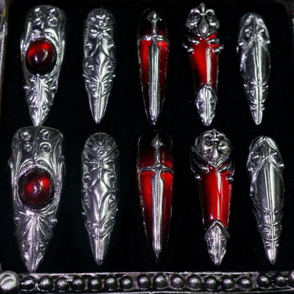 Blood Reliquary press-on nails, detail shot of 3D silver armor and red gems