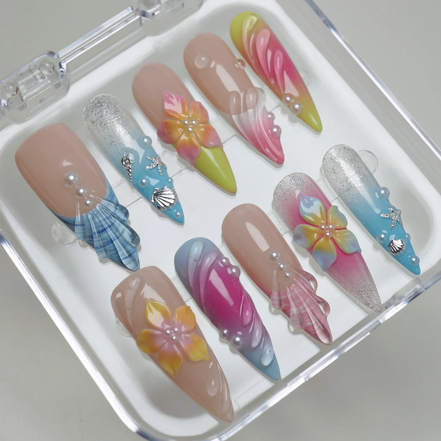 Lushwave press-on nails on display showing the full tropical sunset and ocean wave nail art collection – Donailsart