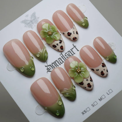 B7 | Palm Kiss press-on nails on display showing the full nude and green floral summer nail art collection – Donailsart