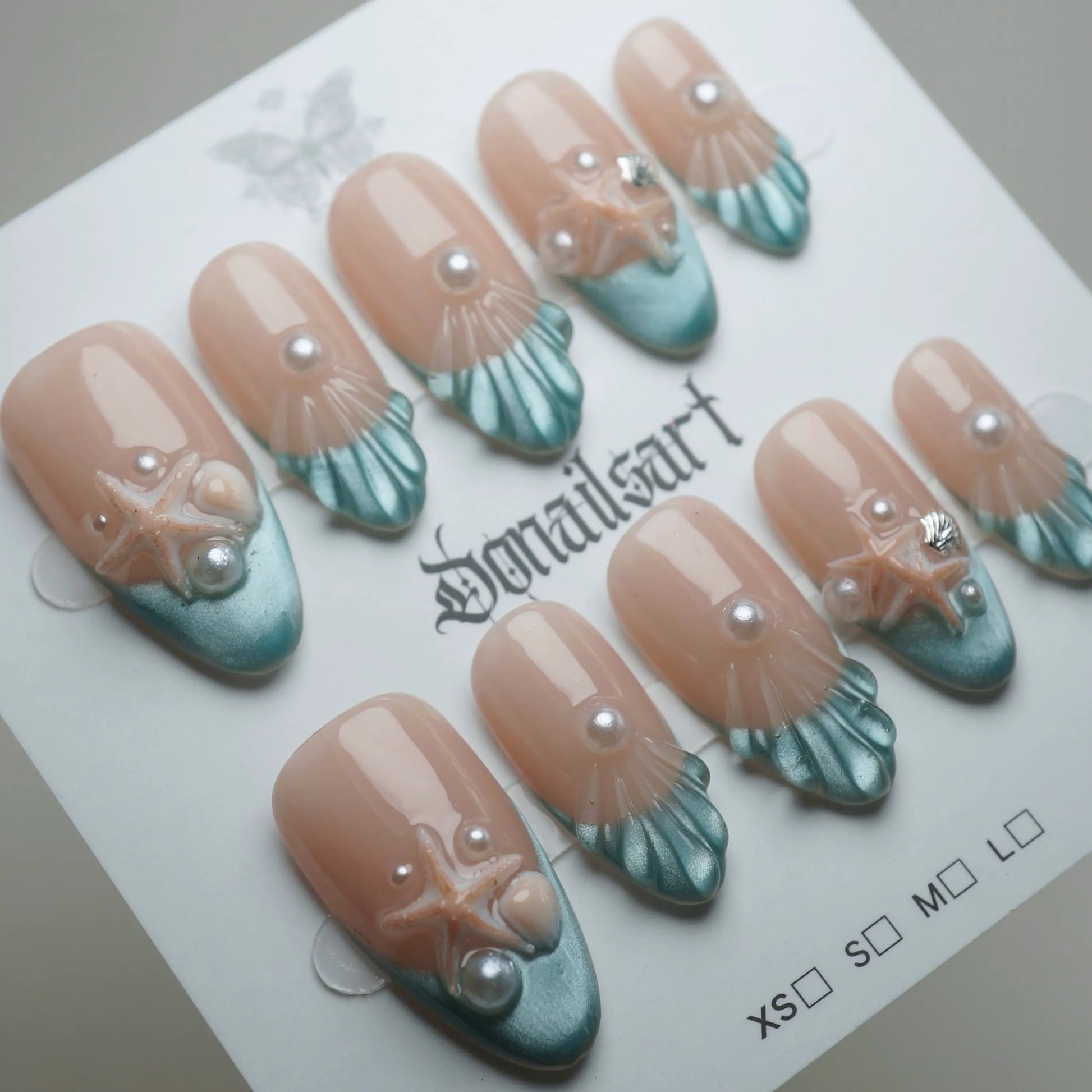 B2 | Ocean Pearl press-on nails on display showing the full ocean pearl nail art collection – Donailsart