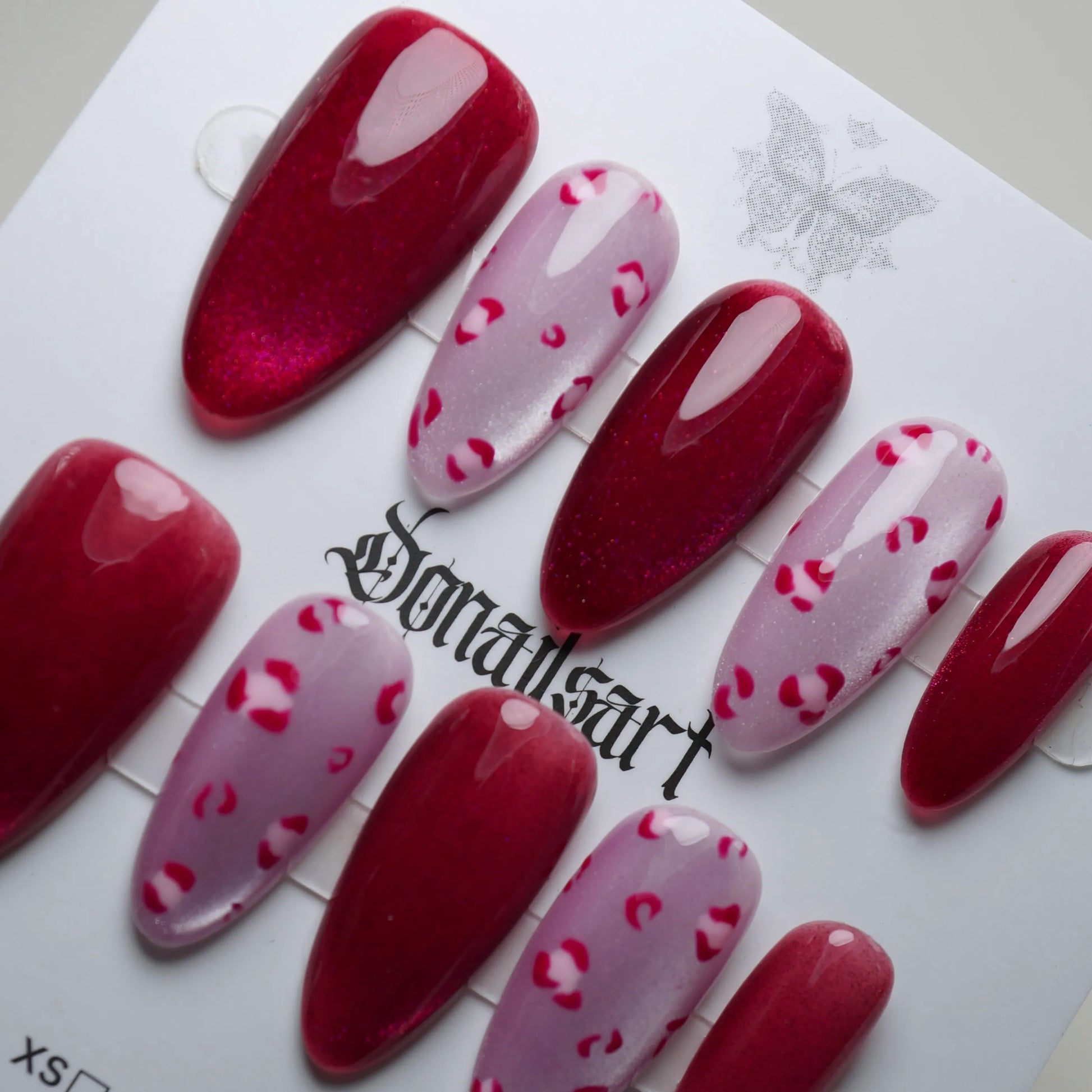 B8 | Sugar Kisses press-on nail set product view with bold crimson red shimmer and leopard accent nail art by Donailsart