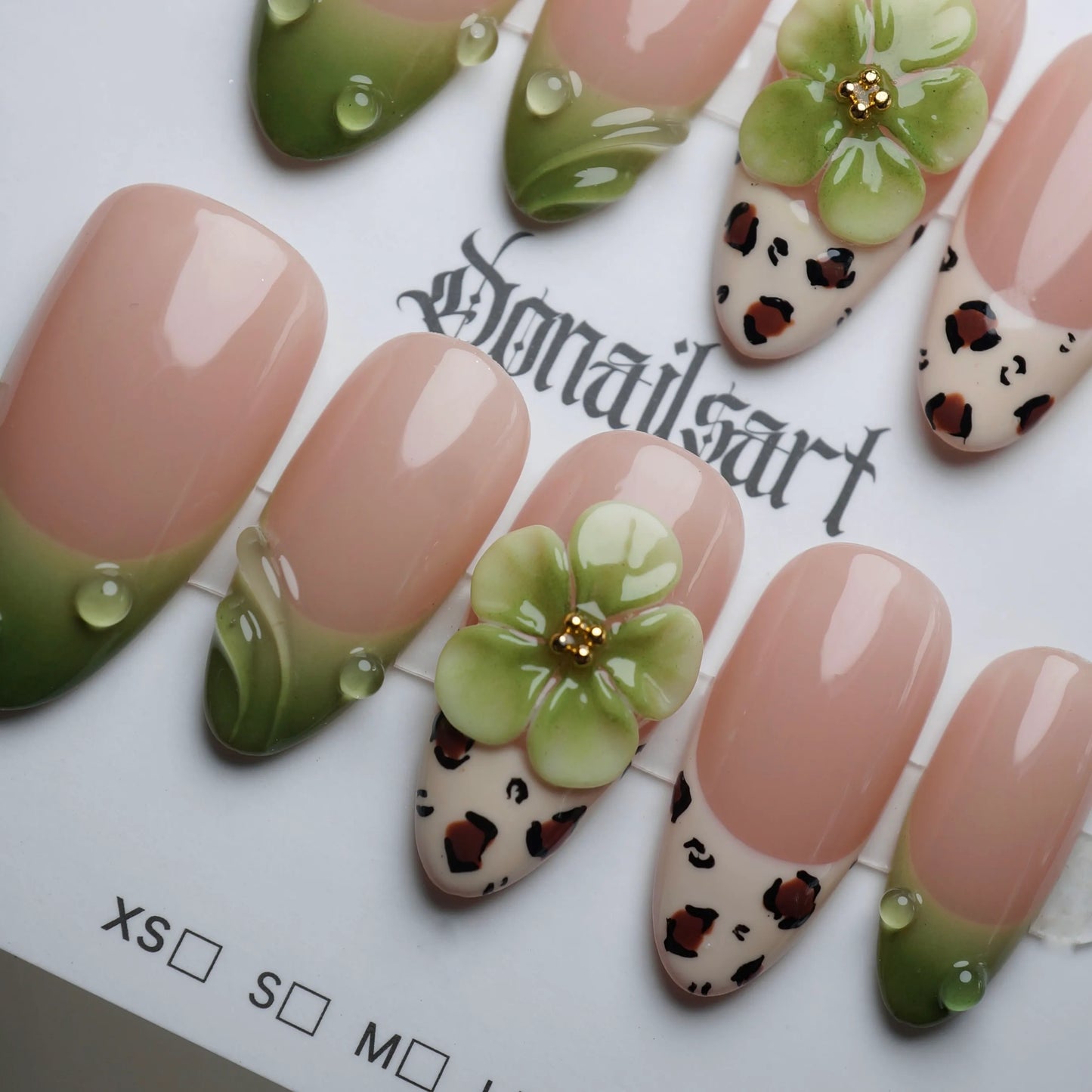 B7 | Palm Kiss close-up detail showing fresh green tips and delicate floral accents on a clean nude nail – Donailsart