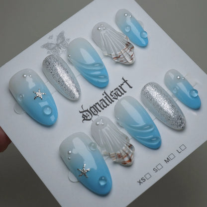 A30 | Blue Lagoon press-on nails on display showing the full soft blue gradient ocean nail art collection – Donailsart