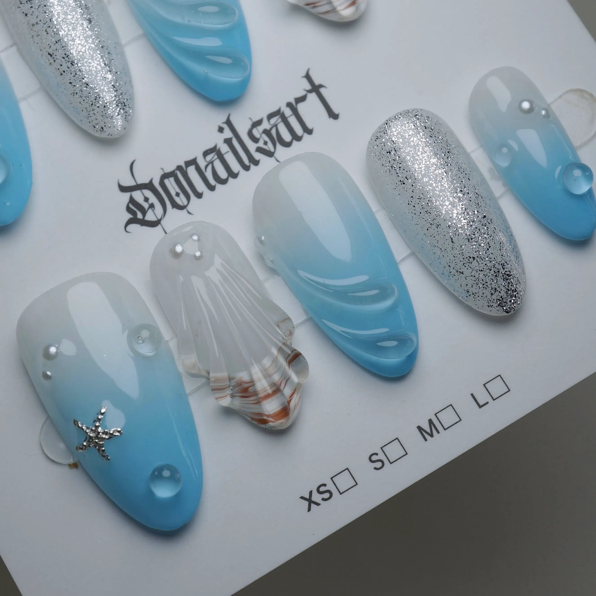 A30 | Blue Lagoon press-on nail set product view with serene soft blue ocean gradient, shell, and shimmer nail art by Donailsart