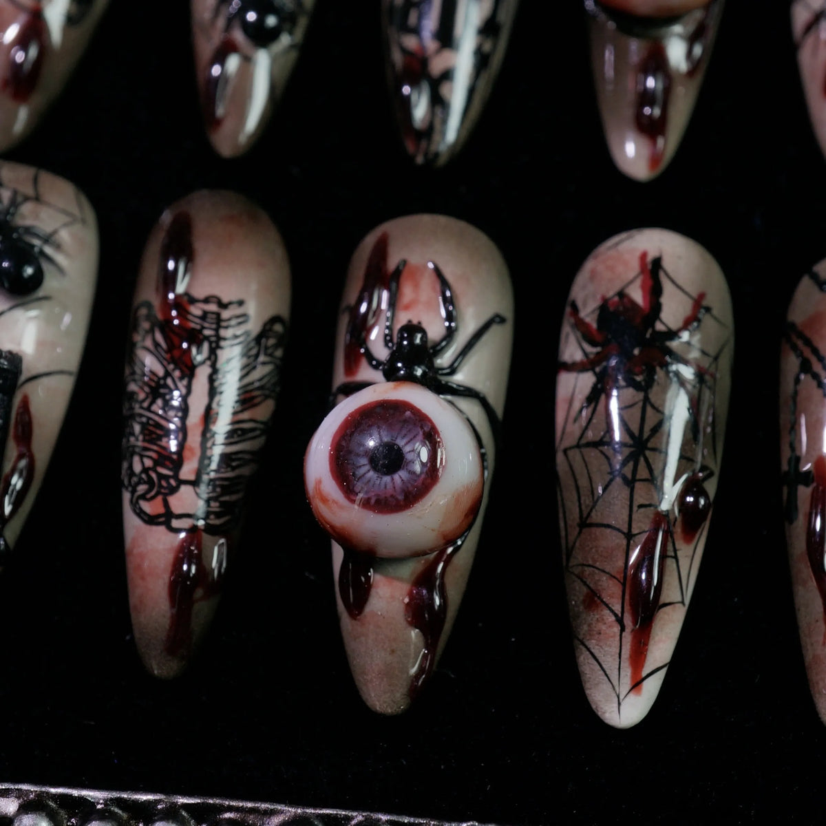 Creeping Gaze press-on nails, detail shot of 3D eyeballs and skulls