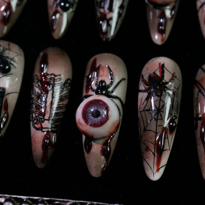 Creeping Gaze press-on nails, detail shot of 3D eyeballs and skulls