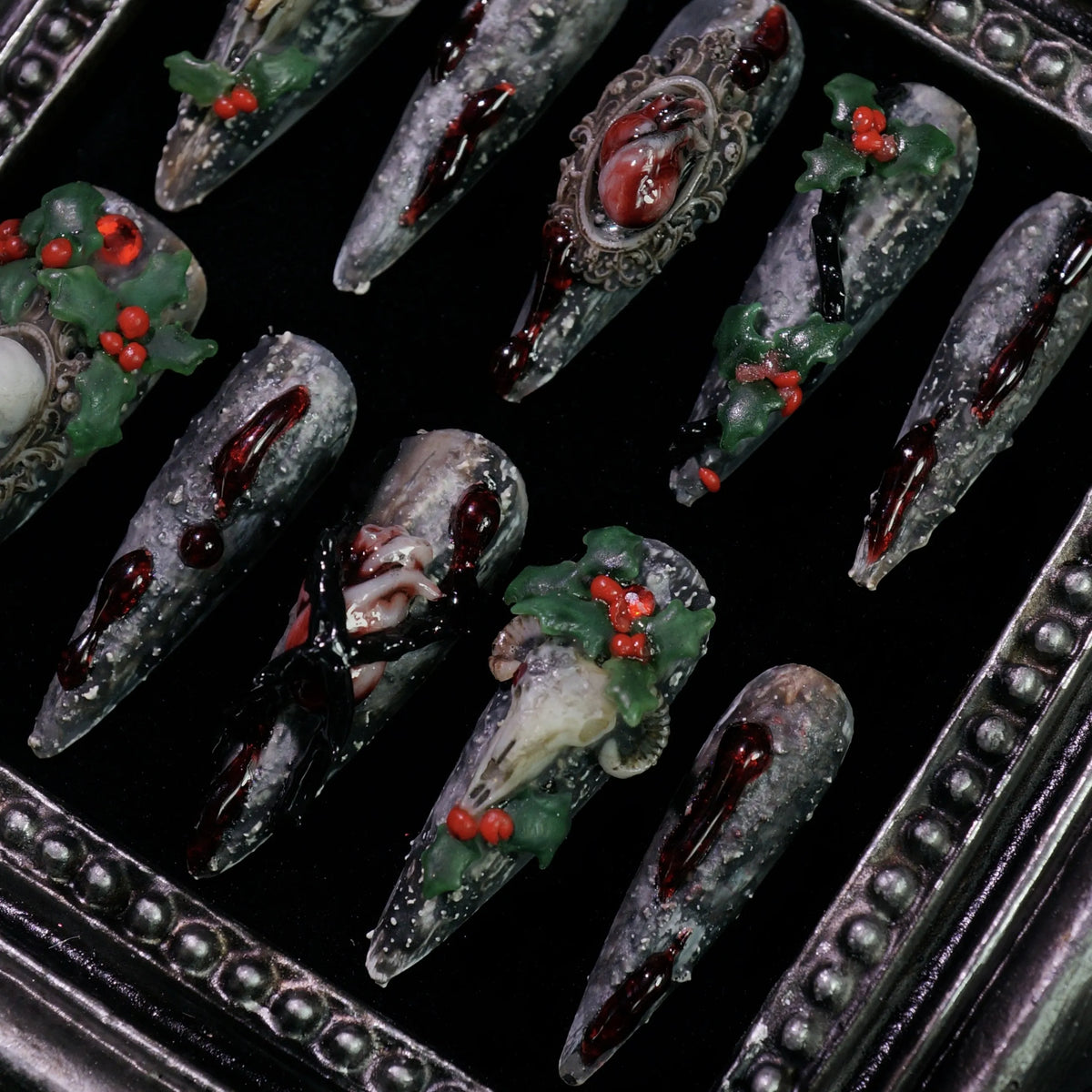 Baphomet x Christmas press-on nails, detail shot of occult goat skulls and holly