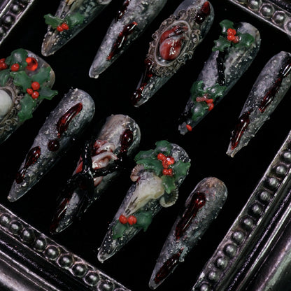 Baphomet x Christmas press-on nails, detail shot of occult goat skulls and holly