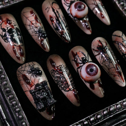 Creeping Gaze press-on nails, close-up of 3D eyeballs and skulls