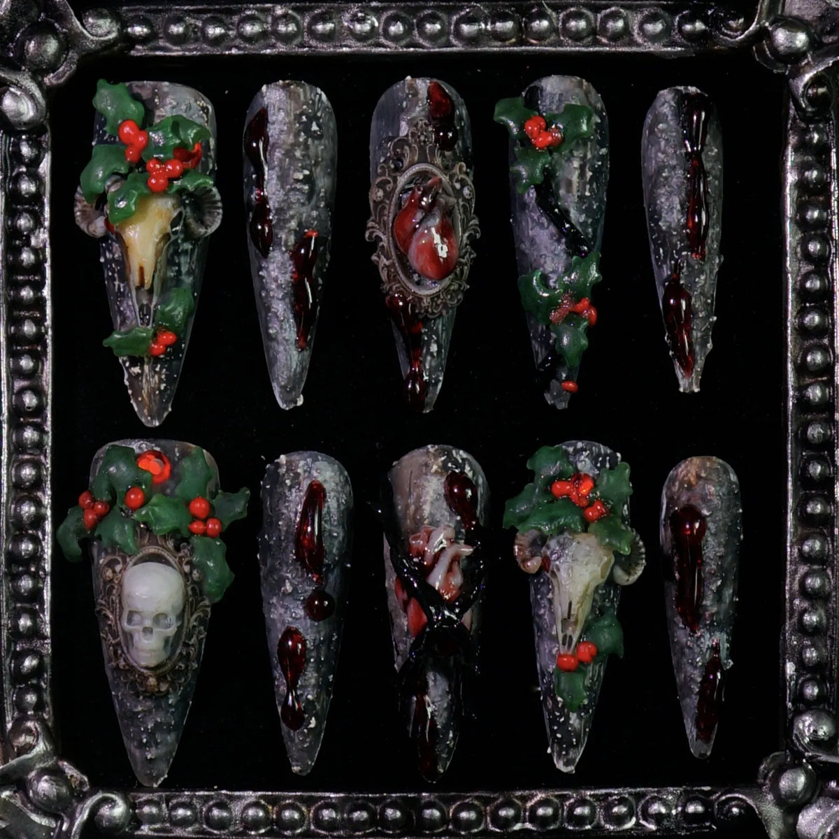 Baphomet x Christmas press-on nails: black stone-textured nails with occult goat skulls and red-green holiday details