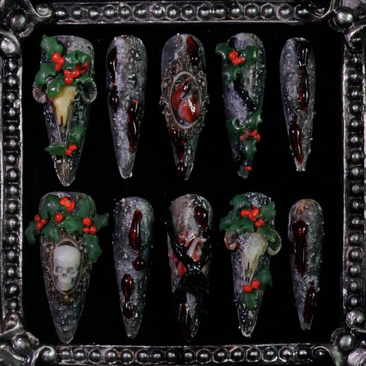 Baphomet x Christmas press-on nails: black stone-textured nails with occult goat skulls and red-green holiday details