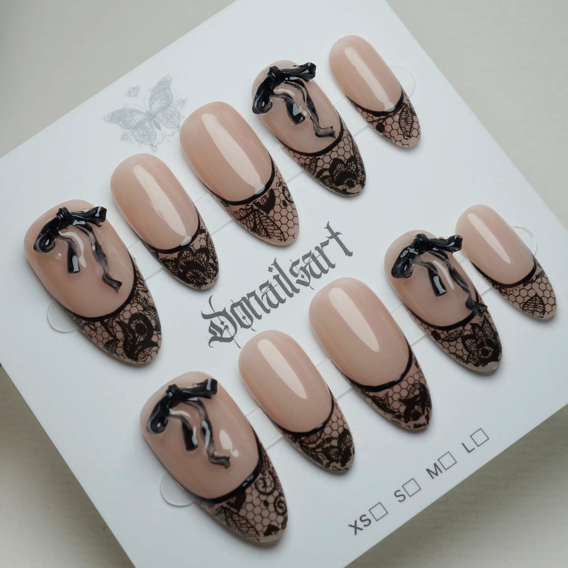B4 | Sexy Lady press-on nails on display showing the full sheer nude and black lace nail art collection – Donailsart